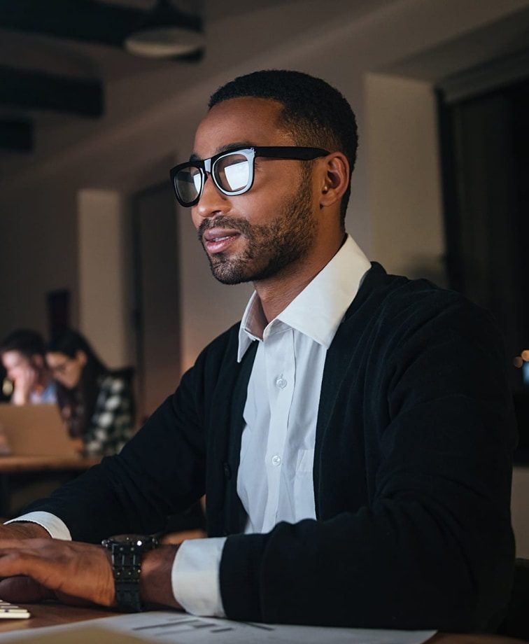 Student sat at a computer to work on the Roadmap MBA