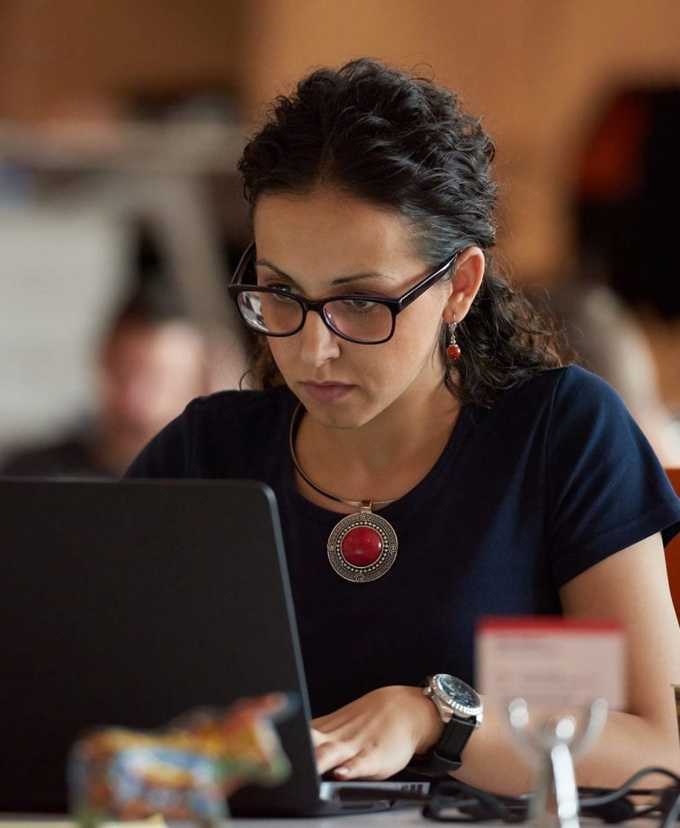 Lady sat at her desk using a laptop computer working on her education