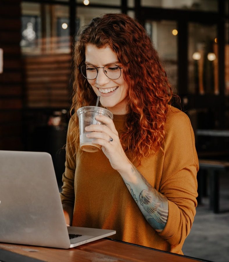 Free Business Training, A career professionals on a laptop having a drink enjoying the Roadmap MBA