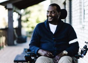 Young man outside in a wheelchair excited for the future