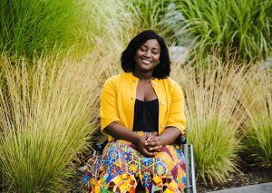 A young lady outside in a wheelchair enjoying life